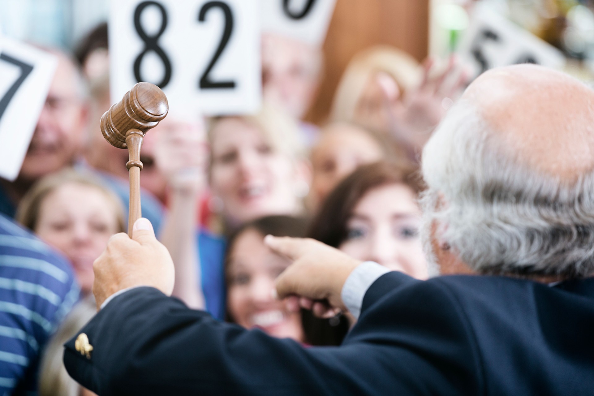 Auctioneer with Large Crowd of Buyers